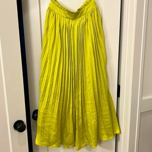 Promesa pleated neon yellow silk skirt
